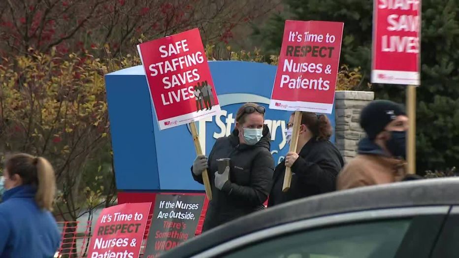 Striking nurses are shown on the picket line outside St. Mary Medical Center.