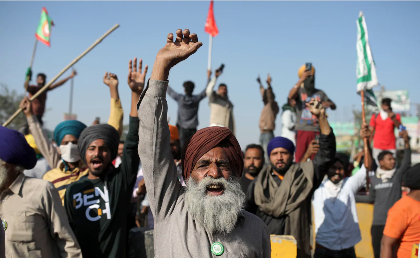 Protesters in India raise their fists.