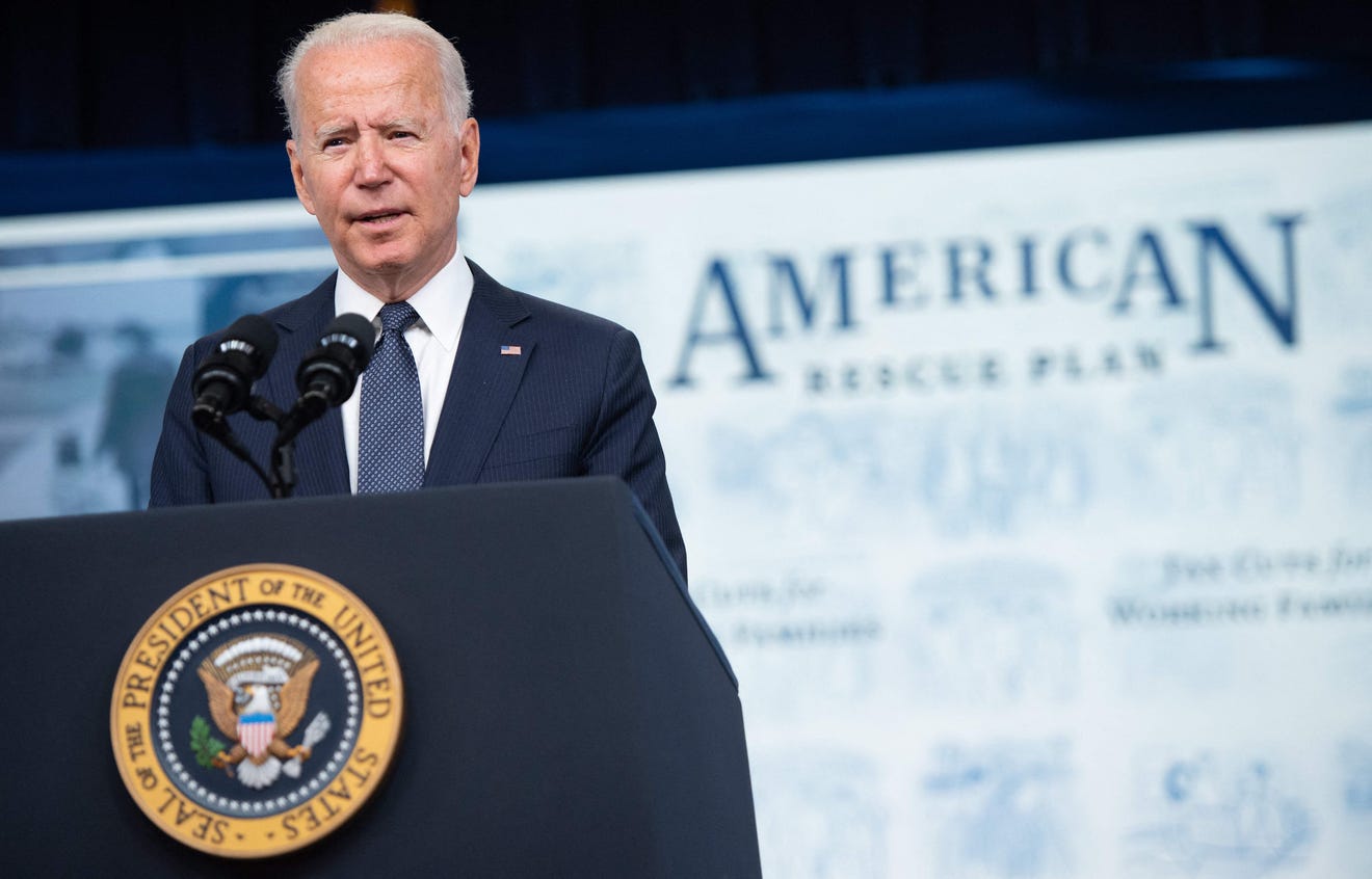 Joe Biden stands behind a podium giving a speech