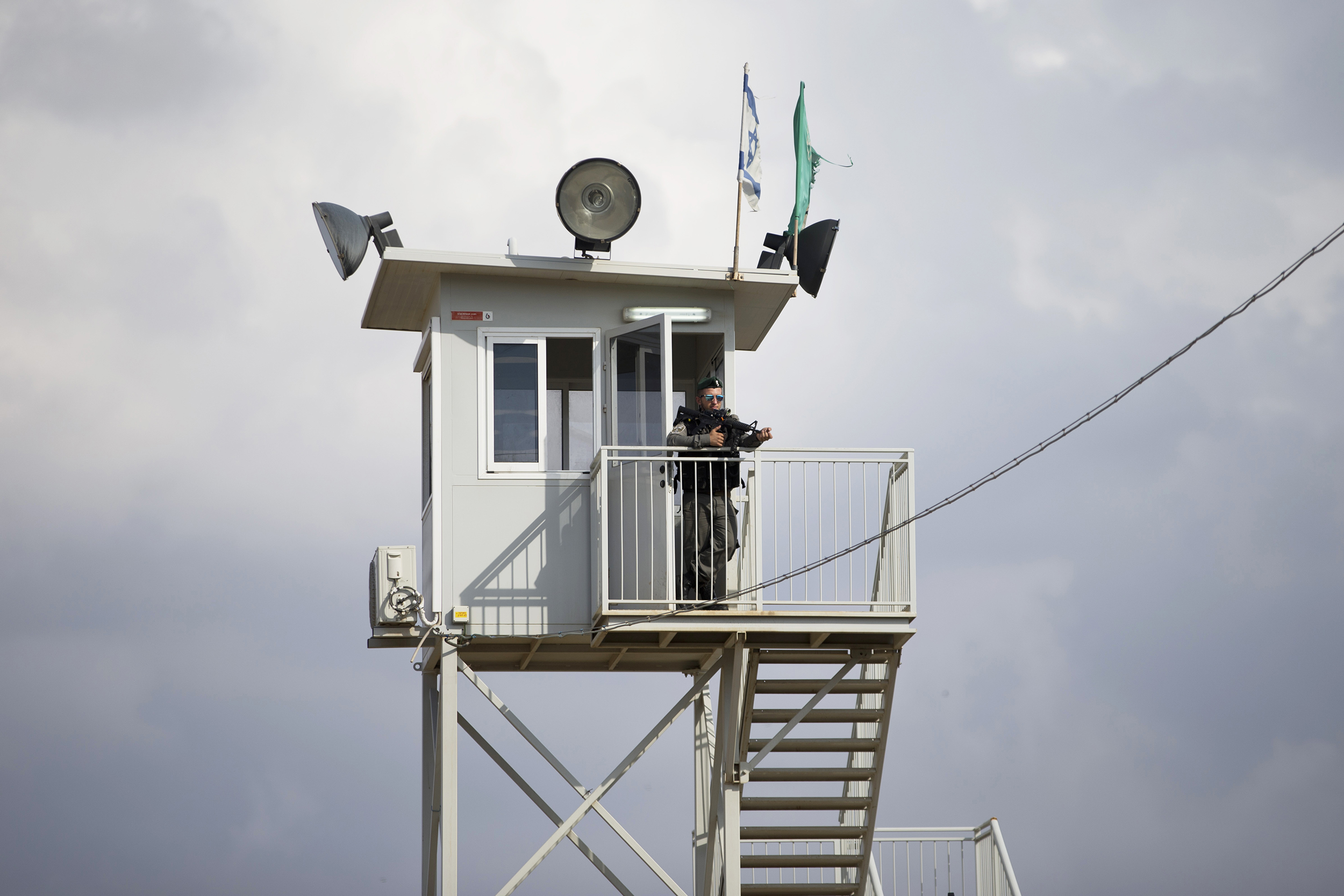 An Israeli border police officer watches from a tower at a checkpoint near the West Bank town of Nablus, Friday, Oct. 30, 2015. Israeli police said two Palestinians ran toward the West Bank checkpoint with knives in their hands, drawing Israeli fire that killed one and wounded the second.