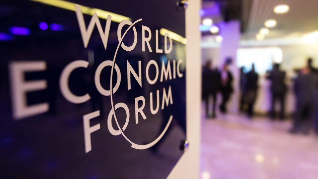 Inside a World Economic Forum building, the logo is on the left.