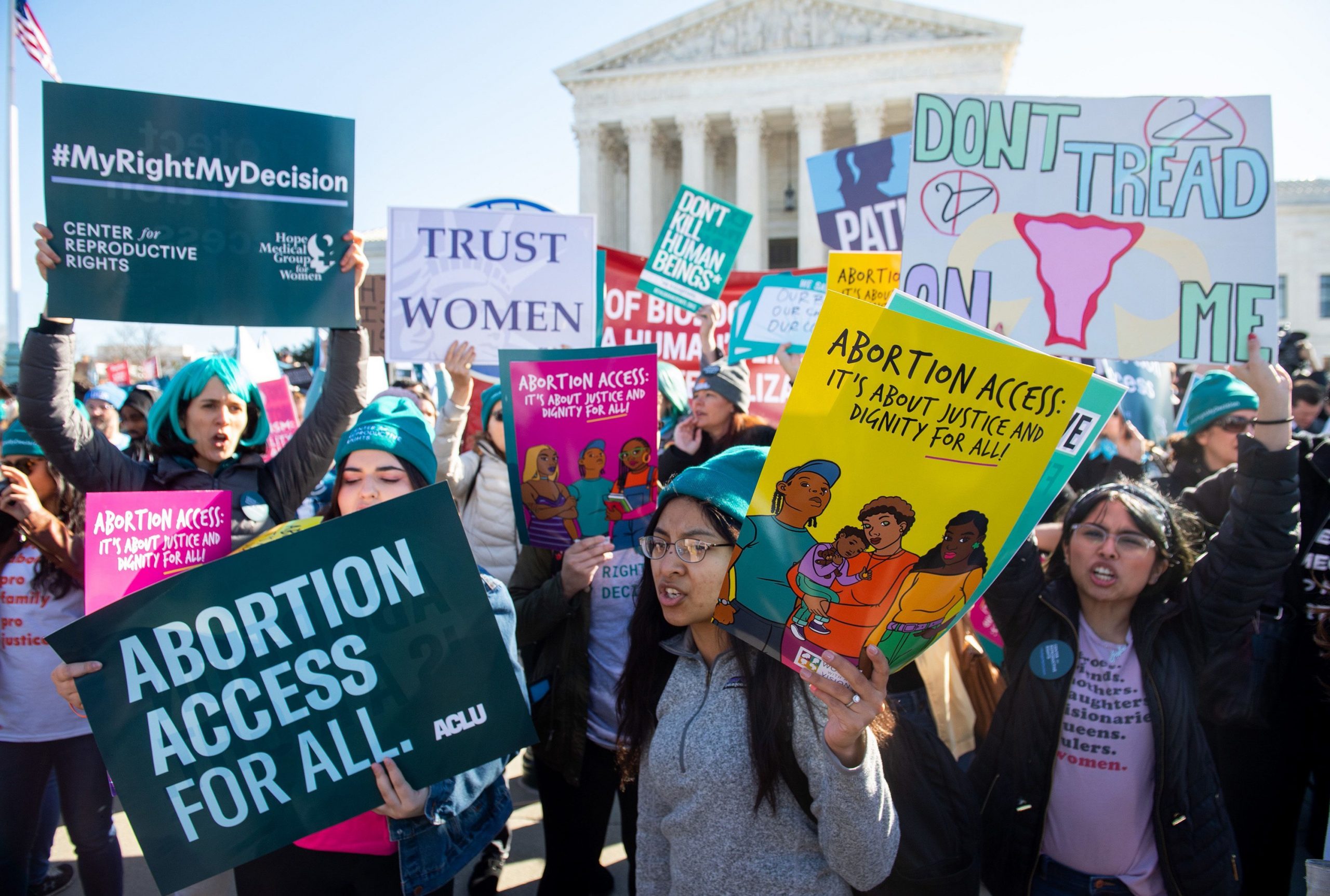 People at a pro-choice protest in front of a government building in Washington, D.C.