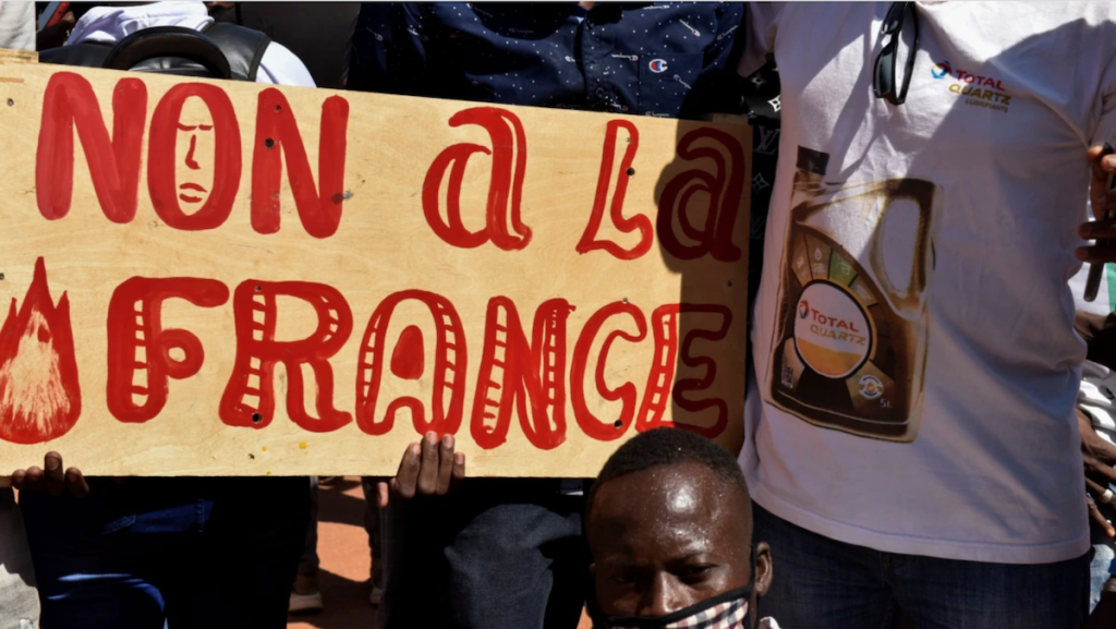 Protest in Burkina Faso, a large sign reads "Non a la France" (No to France)