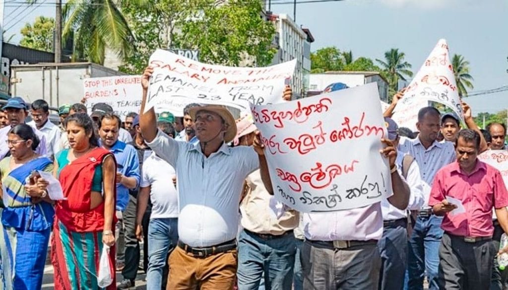 Sri Lankalı öğretmenler protesto gösterileri ve pankartlar tutuyor