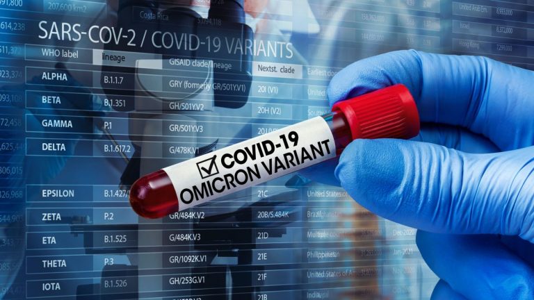 A blue-gloved hand holds a red vial that reads "COVID-19 Omicrom Variant"