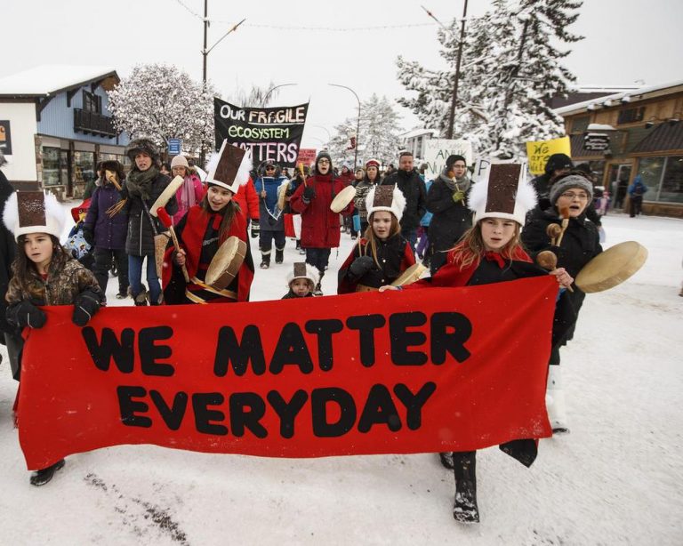 Wet'suwet'en people resist Coastal GasLink in Canada in winter 2020. They hold a banner that reads, "We matter everyday."