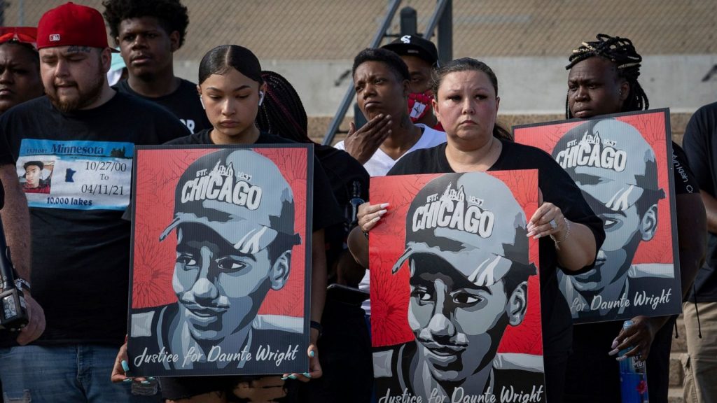 Family members of Daunte Wright hold signs with his image protest8ing in St. Paul Minnesota