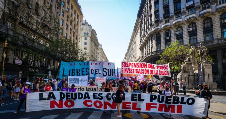 Protesters hold a banner that says 'The debt is with the people, not the IMF' at a rally in Buenos Aires.