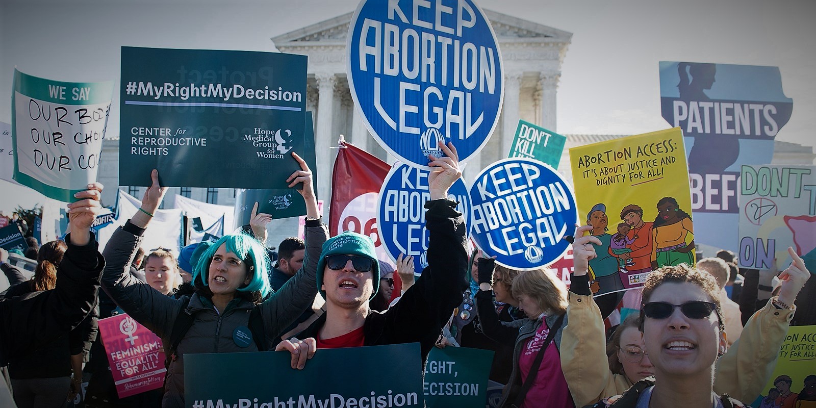 Marchers holding signs that read "keep abortion legal"