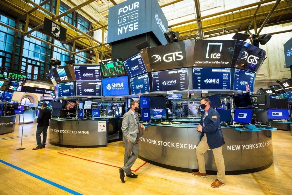 Three men at the New York Stock Exchange