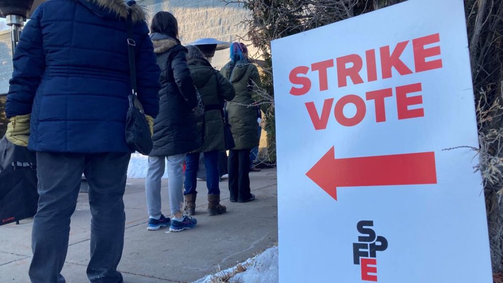 Minnesota teachers standing in line outside to vote to authorize a strike.