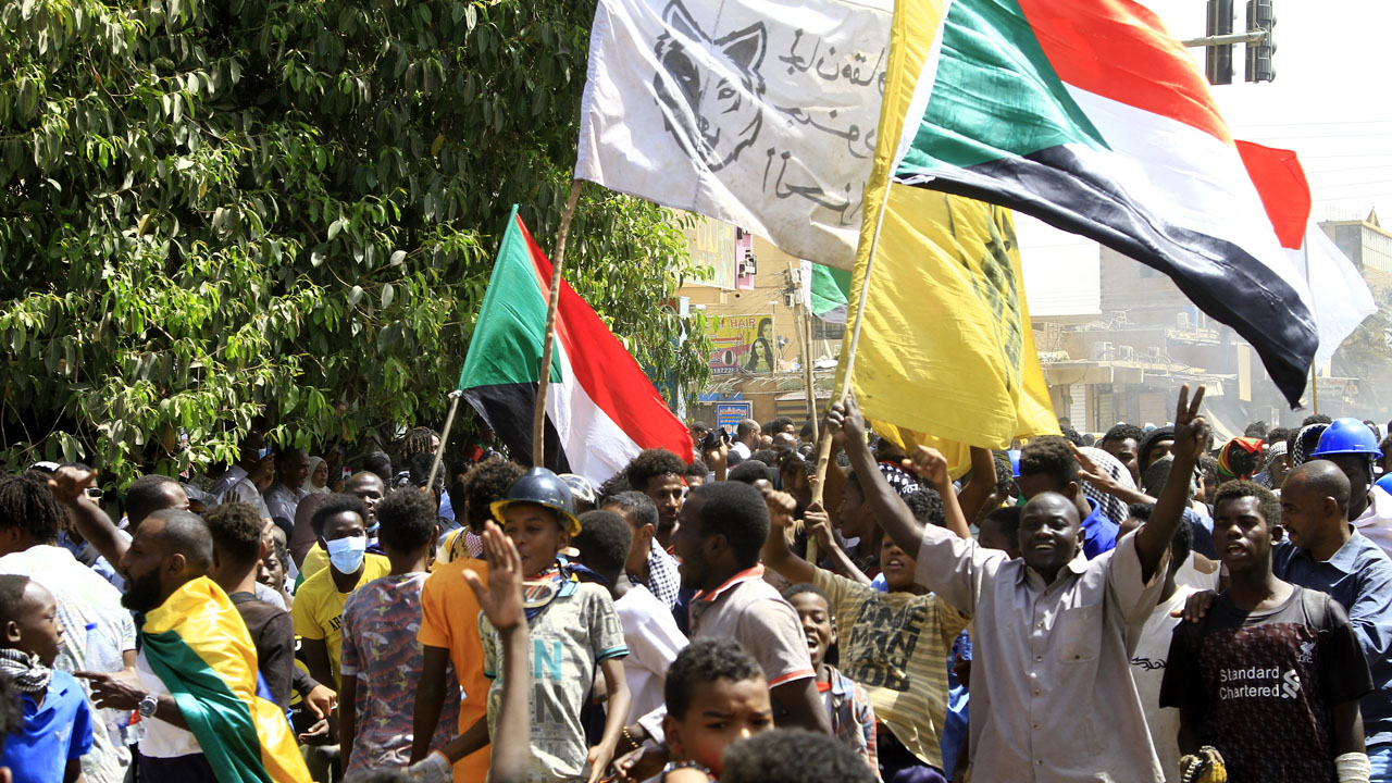 Sudanese protesters take part in ongoing demonstrations calling for civilian rule and denouncing the military administration, in Sudan’s capital Khartoum on March 14, 2022. – Sudanese security forces opened fire Monday as protesters in several cities across the northeast African nation marched against military rule and a worsening economic situation, witnesses said.