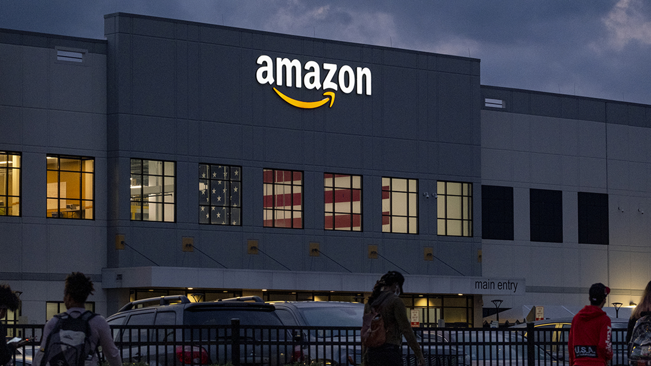 People arrive for work at the Amazon distribution center in the Staten Island borough of New York, Monday, Oct. 25, 2021. Earlier in the day, Chris Smalls, president of the Amazon Labor Union, delivered "Authorization of Representation" forms to the National Labor Relations Board in New York, as Union organizer have delivered more than 2,000 signatures to federal labor officials in a bid to unionize workers at Amazon's Staten Island distribution center.