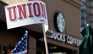 es a sign that read “unionize” near the Country Club Plaza Starbucks store where dozens of Starbucks employees and union supporters protested alleged anti-union tactics by the company Thursday, March 3, 2022.