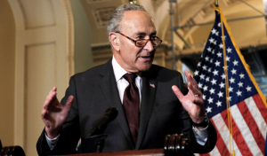 Chuck Schumer Speaking in front of an American flag
