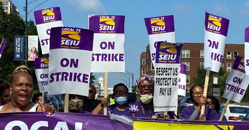 SEIU local 73 march in 2021, carrying "on strike" signs.