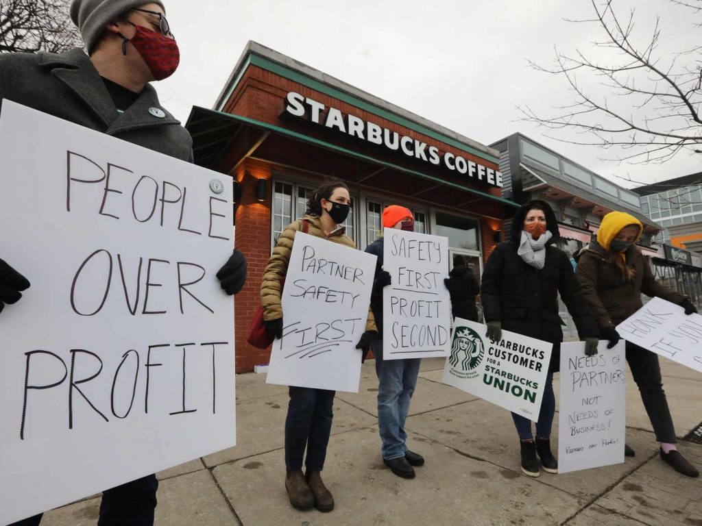 Unionized Starbucks workers picket outside the Elmwood Avenue location in Buffalo after walking off the job due to what they say are unsafe working conditions, Wednesday, Jan. 5, 2022.