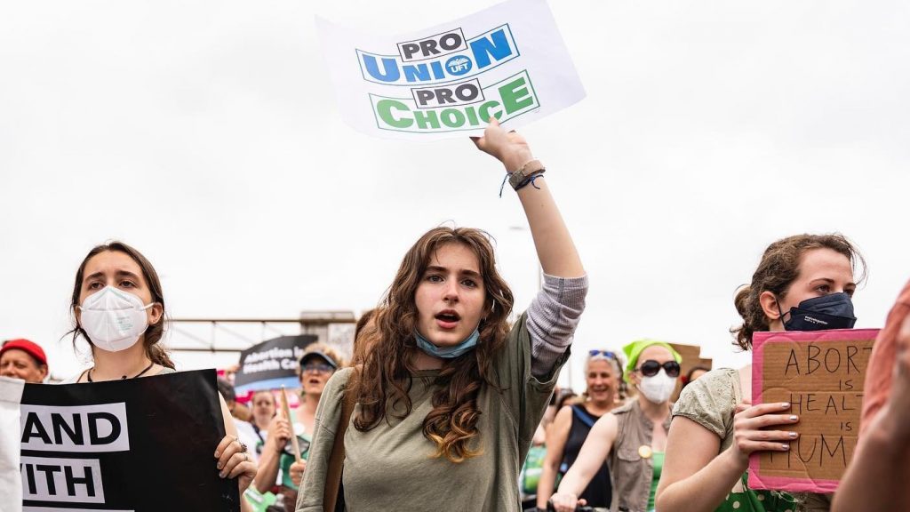 Protester holds a sign that reads "Pro Union, Pro Choice"