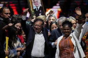 Former rebel Gustavo Petro and his running mate Francia Marquez, celebrate before supporters after winning a runoff presidential election in Bogota, Colombia, Sunday, June 19, 2022.