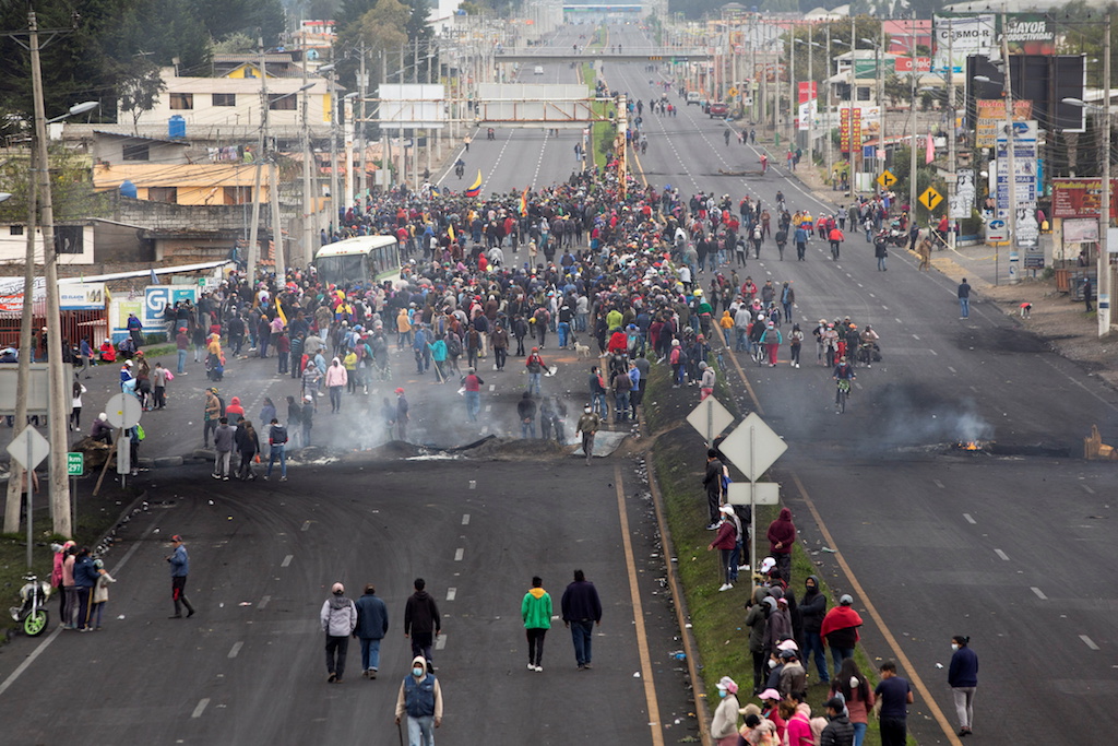 Indigenous demonstrators gather around burning road blockades while marching towards the capital Quito after a week of protests against the economic and social policies of President Guillermo Lasso, in Machachi, Ecuador June 20, 2022.
