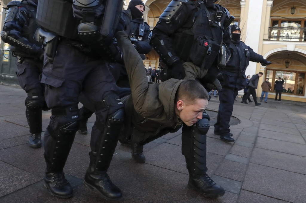 Russian protester being arrested by Russian police.