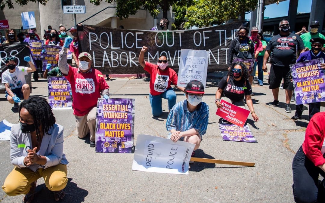 People at a BLM protest in 2020, a banner reads "Police out of the labor movement"