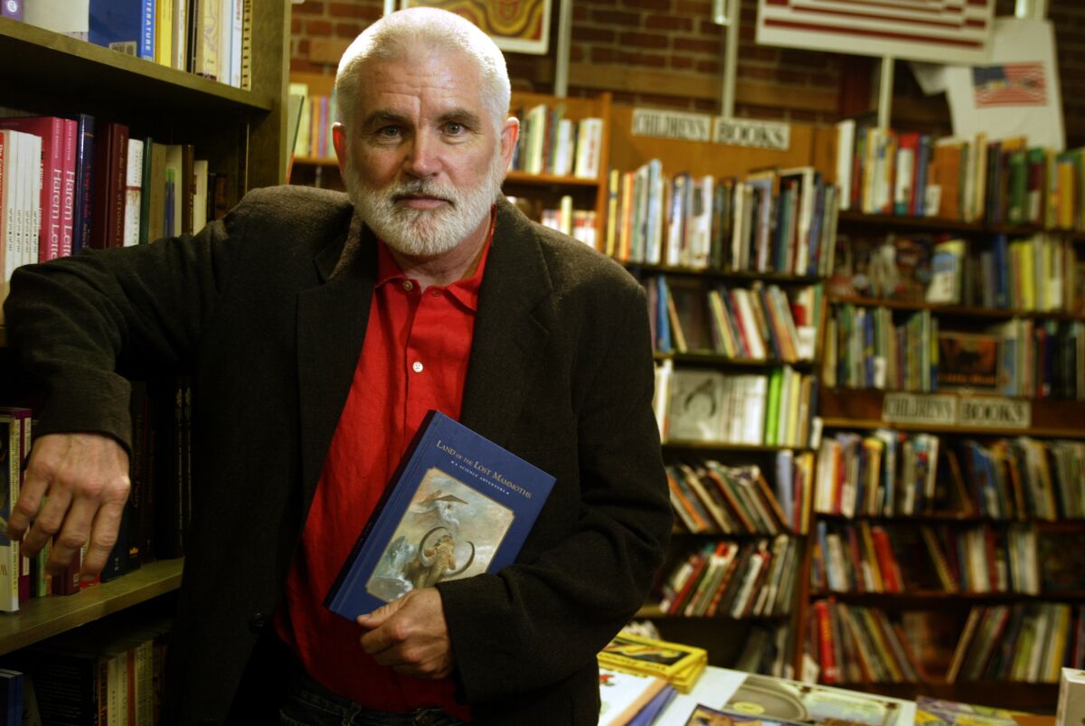 Mike Davis stands holding a book in 2004.