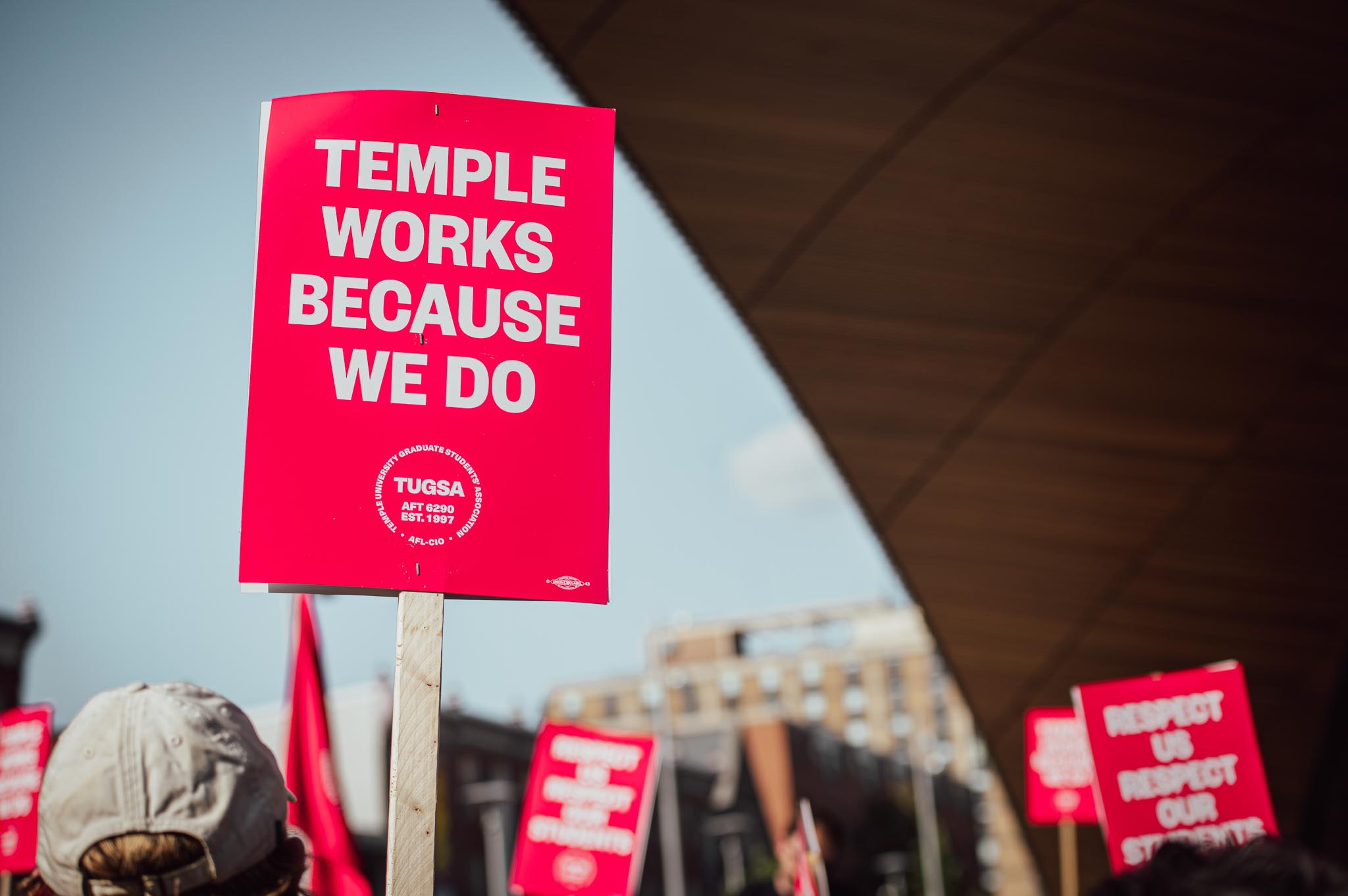 The Temple Student Graduate Association TUGSA at a rally in October 2022, a sign reads "Temple works because we do."