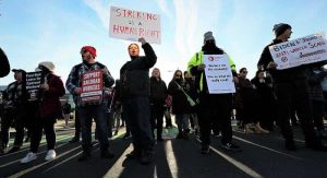 Protesters holding signs supporting rail workers