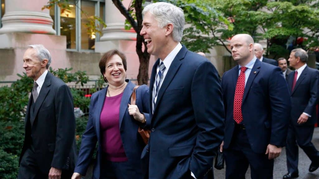 Supreme court justices laughing while walking at Harvard University