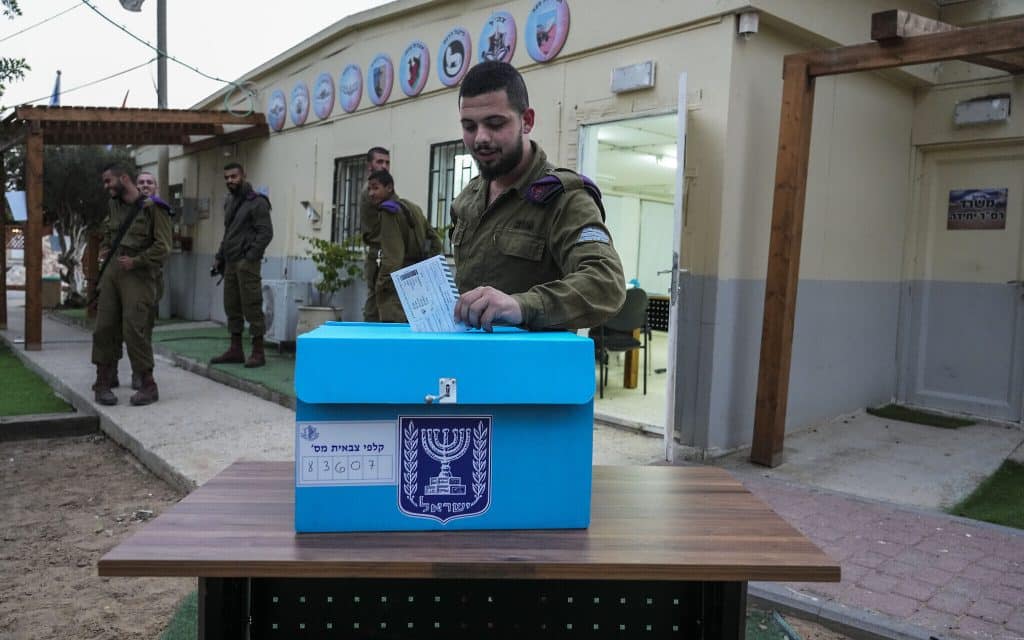 An Israeli soldier casts an early vote at an army base near the Israeli Kibbutz Kerem Shalom near the border with Gaza Strip, October 31, 2022
