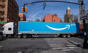 n Amazon Prime tractor-trailer carries goods through heavy traffic March 22, 2022 in the Brooklyn borough of New York City.