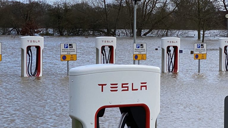 Tesla car chargers partly submerged after a storm.