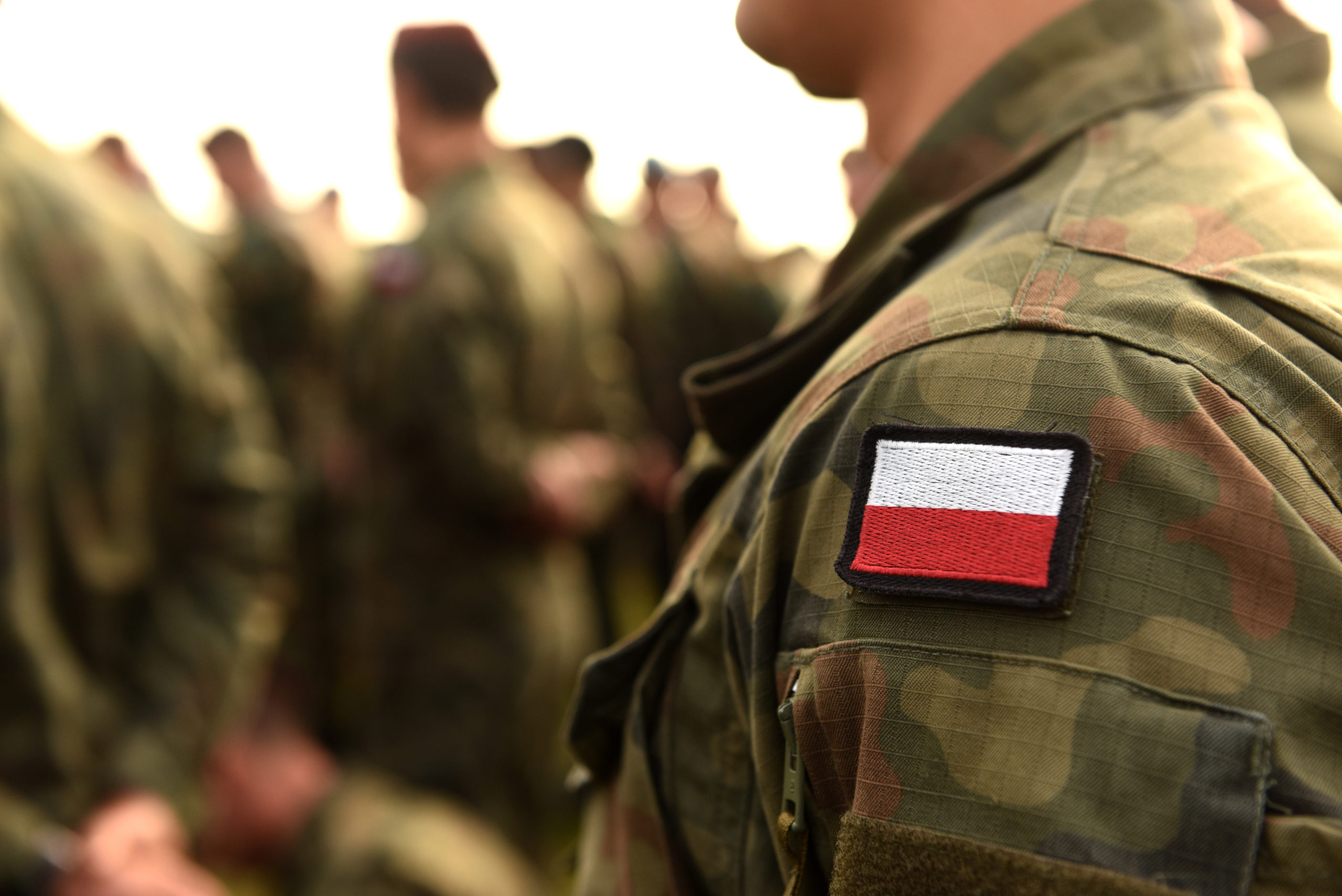 Polish soldiers, a zoom-in on a Polish flag on their uniform.