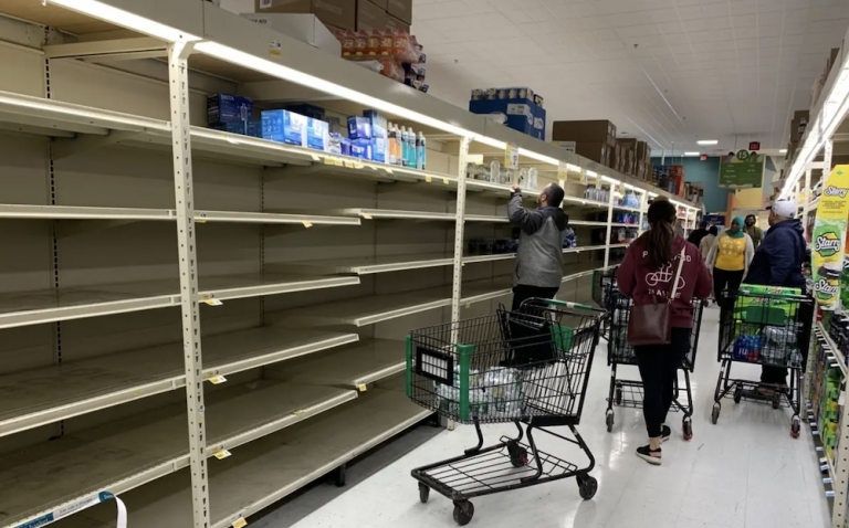 Customers clear shelves of water Sunday at Fresh Grocer in West Philadelphia.