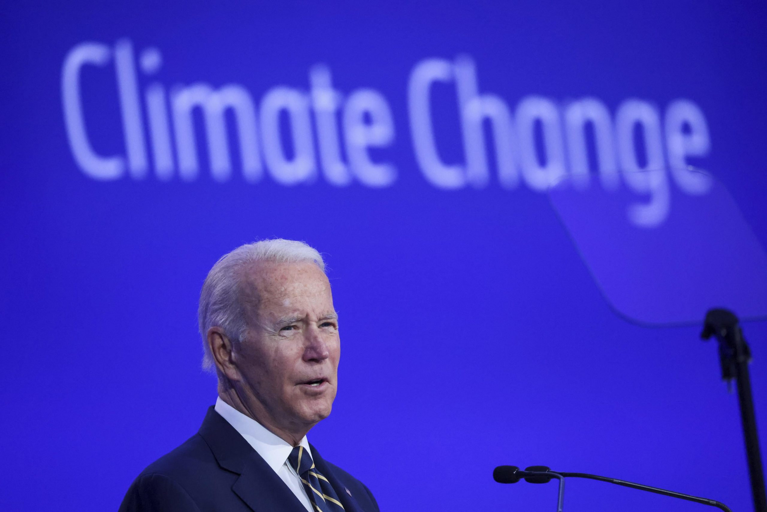 Biden speaking at a podium at COP26 in Glasgow in 2021.
