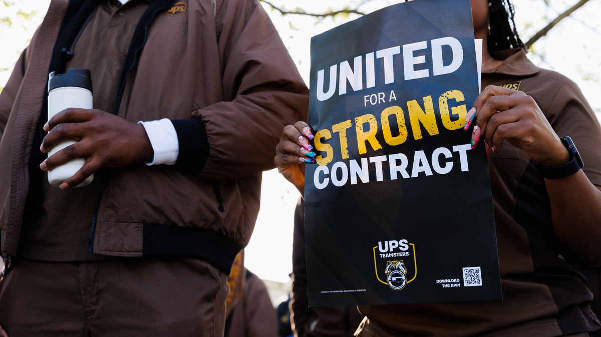 UPS workers hold a sign that reads "United for a strong contract."