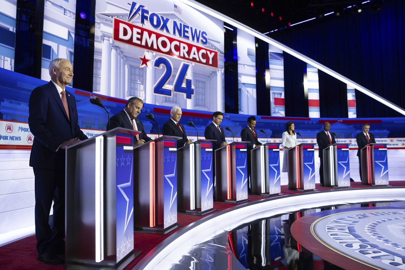 Republican candidates for the 2024 election stand in a row at podiums for the first debate of 2023.