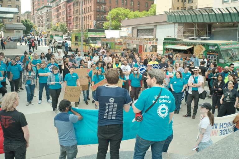 Mount Sinai Hospital workers wear blue at a picket. Postdocs have overwhelmingly voted to strike.