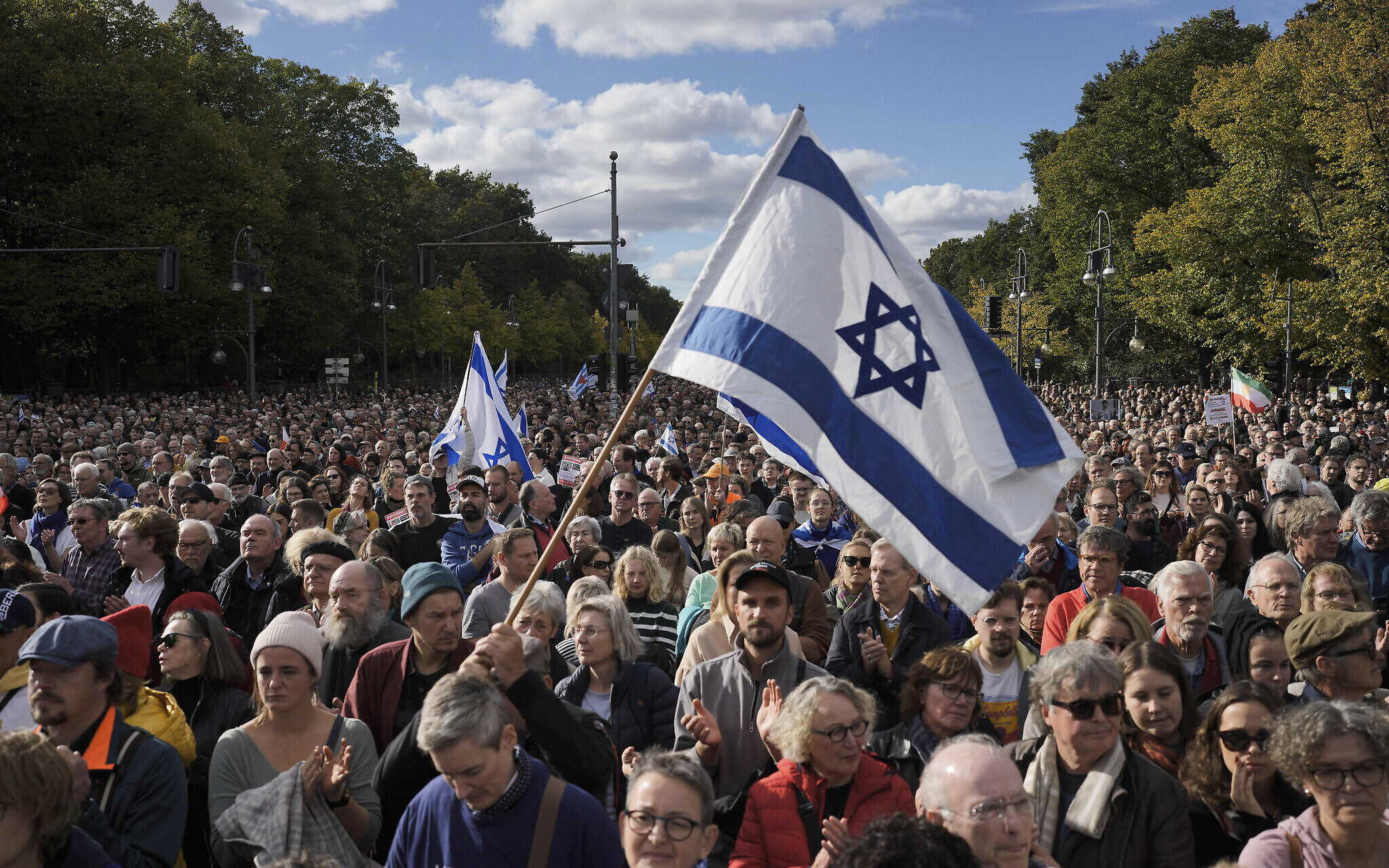 People waves Israeli flags during a demonstration against antisemitism and to show solidarity with Israel in Berlin, Germany, Sunday, Oct. 22, 2023.