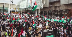 Thousands march in Detroit for Palestinian rights, waving flags. October 2023.
