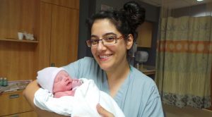 Dr. Ghazal Moayedi (OB/GYN) holding a newborn baby. Her speech was cancelled at Montefiore Medical Center following a pro-Palestine social media post.