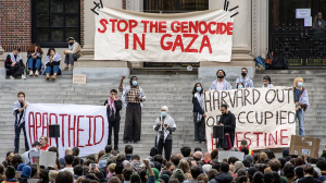 Students protesting outside Harvard University. The banner reads "STOP THE GENOCIDE IN GAZA". October 2023.
