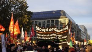 A banner reads "stop the genocide" at a pro-Palestine protest at FU in Germany