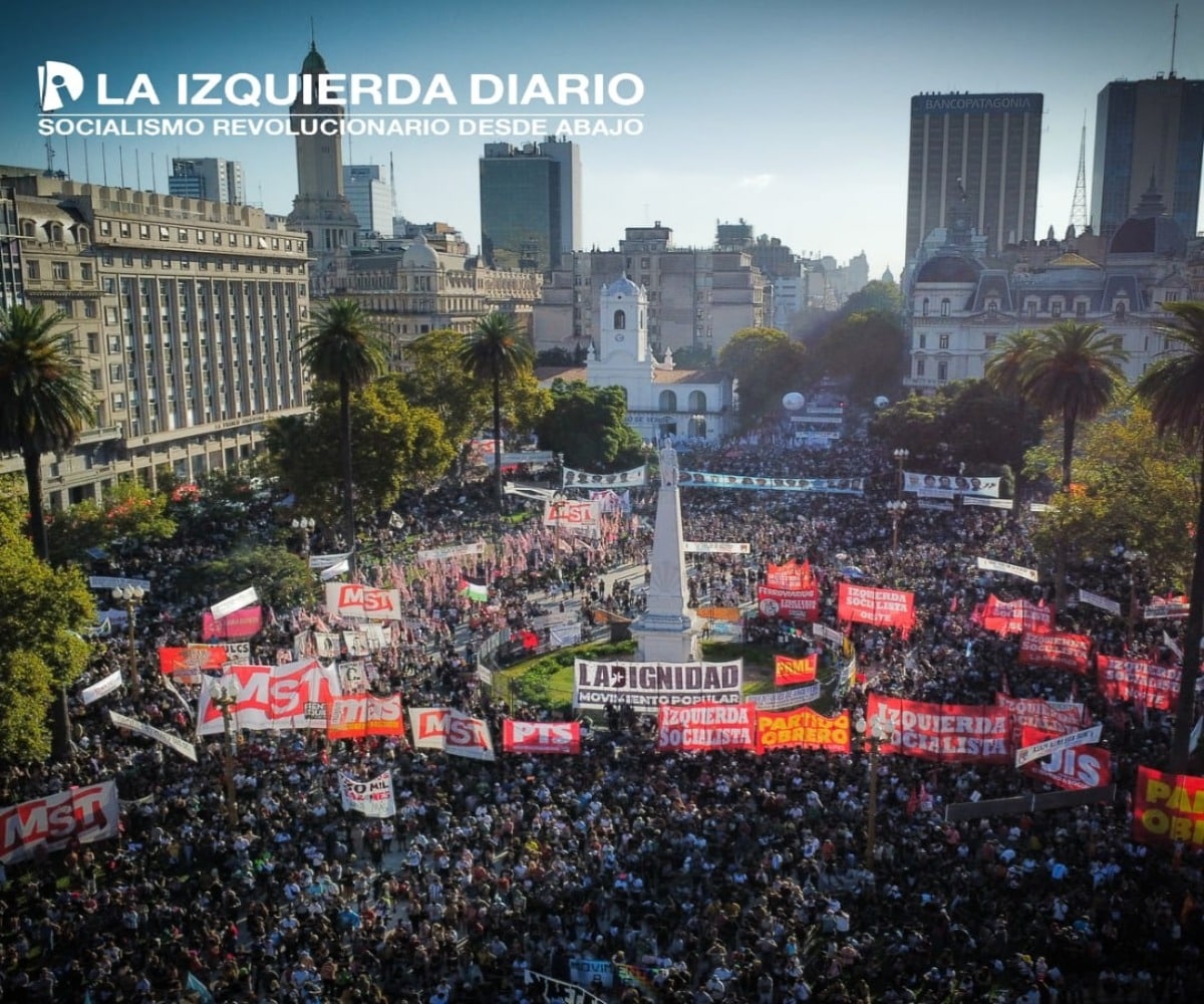 A square in Argentina is full of protesters holding red banners