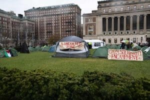 A tent encampment at Columbia University decorated with two signs that say "Liberated Zone" and "Gaza Solidarity Encampment"