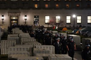 A stream of cops in riot gear pour into Columbia University,